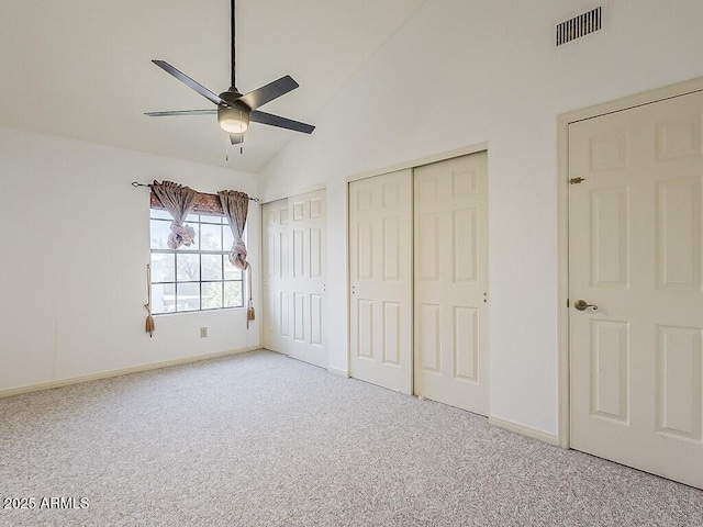 13064 N 100th Pl, Scottsdale, AZ 85260 - unfurnished bedroom featuring multiple closets, carpet, baseboards, vaulted ceiling, and a ceiling fan