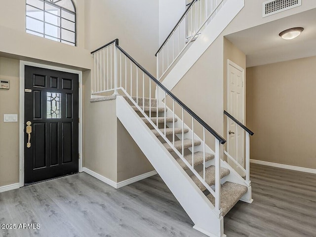13064 N 100th Pl, Scottsdale, AZ 85260 - foyer featuring wood finished floors, stairway, baseboards, and a towering ceiling