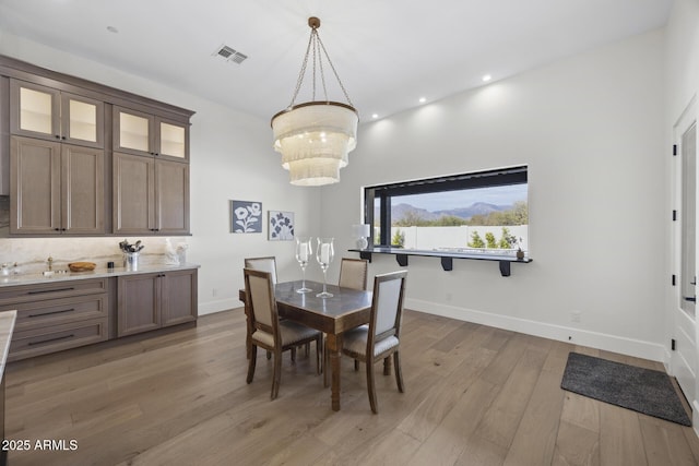 dining room featuring an inviting chandelier and light hardwood / wood-style floors