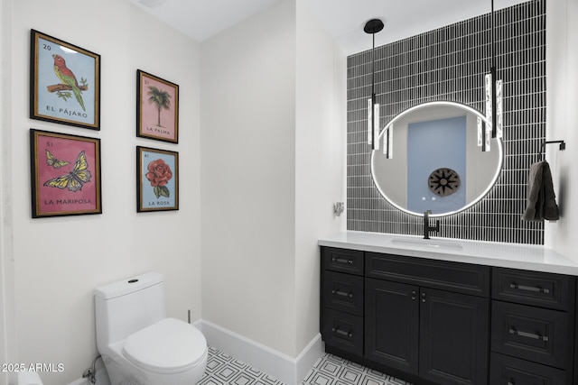 bathroom featuring tile patterned floors, toilet, and vanity