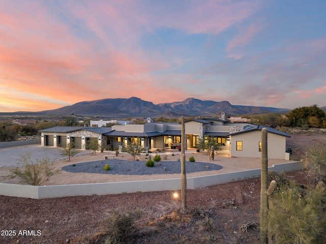 view of front of home with a mountain view and a garage