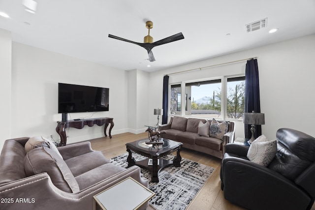 living room featuring ceiling fan and light wood-type flooring