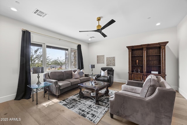 living room featuring light wood-type flooring and ceiling fan