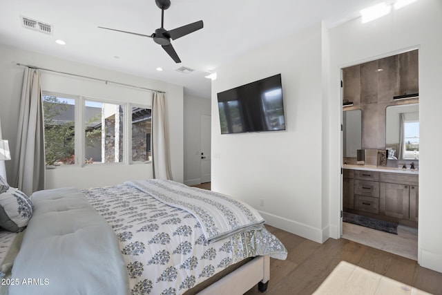 bedroom with ceiling fan, hardwood / wood-style flooring, and ensuite bathroom