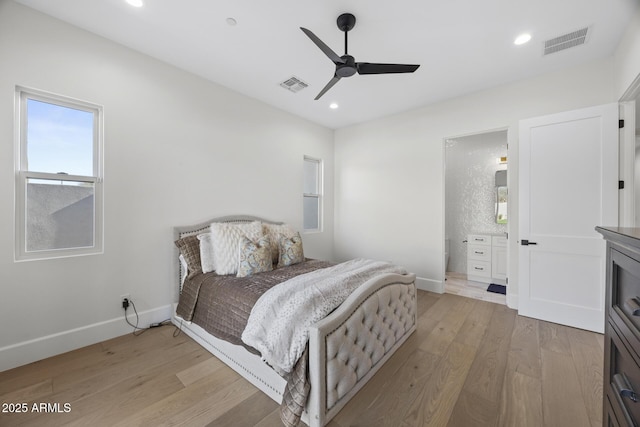 bedroom with ceiling fan, ensuite bath, and light wood-type flooring