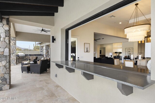 view of patio with ceiling fan, an outdoor living space, and area for grilling