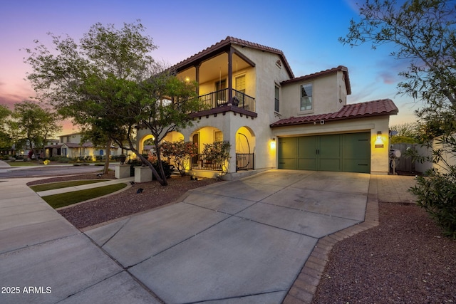 20518 W White Rock Rd, Buckeye, AZ 85396 - mediterranean / spanish home with a balcony, a tile roof, concrete driveway, and stucco siding
