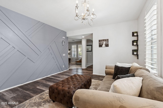20518 W White Rock Rd, Buckeye, AZ 85396 - living room with arched walkways, wood finished floors, and a chandelier