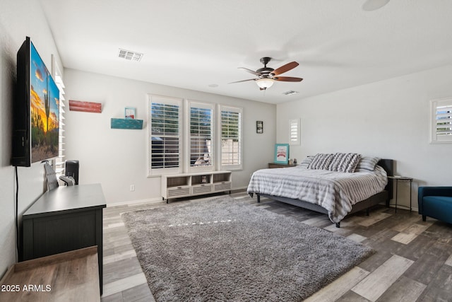 20518 W White Rock Rd, Buckeye, AZ 85396 - bedroom featuring wood finished floors, multiple windows, and ceiling fan