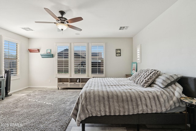 20518 W White Rock Rd, Buckeye, AZ 85396 - bedroom with multiple windows, a ceiling fan, and wood finished floors