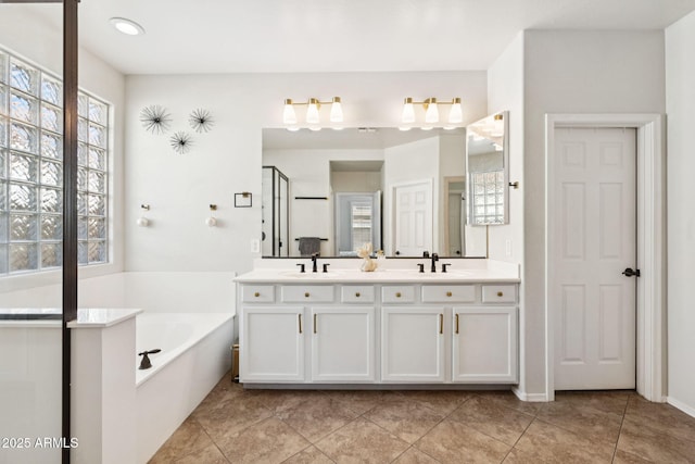 20518 W White Rock Rd, Buckeye, AZ 85396 - bathroom with double vanity, a garden tub, tile patterned flooring, and an enclosed shower