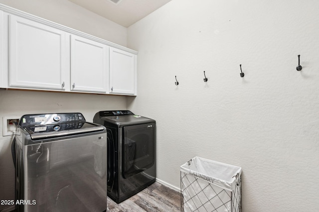 20518 W White Rock Rd, Buckeye, AZ 85396 - washroom featuring cabinet space, washer and clothes dryer, and wood finished floors