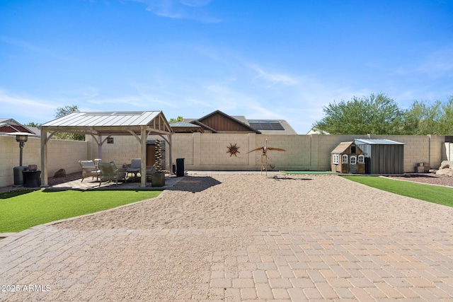 20518 W White Rock Rd, Buckeye, AZ 85396 - fenced backyard featuring a gazebo, a patio area, and an outbuilding