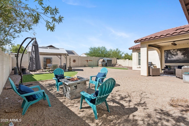 20518 W White Rock Rd, Buckeye, AZ 85396 - fenced backyard featuring a gazebo, a storage unit, a patio area, and an outdoor living space with a fire pit
