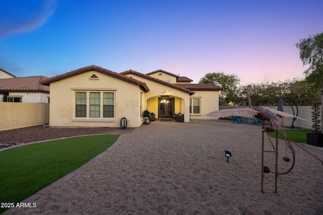 20518 W White Rock Rd, Buckeye, AZ 85396 - view of front facade featuring a fenced backyard, stucco siding, and a tiled roof