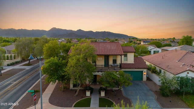 20518 W White Rock Rd, Buckeye, AZ 85396 - view of front of property with a balcony, driveway, a tile roof, stucco siding, and a mountain view