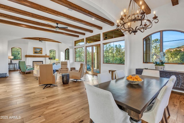 dining area featuring beamed ceiling, french doors, ceiling fan, and light hardwood / wood-style flooring