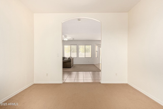 carpeted spare room featuring ceiling fan