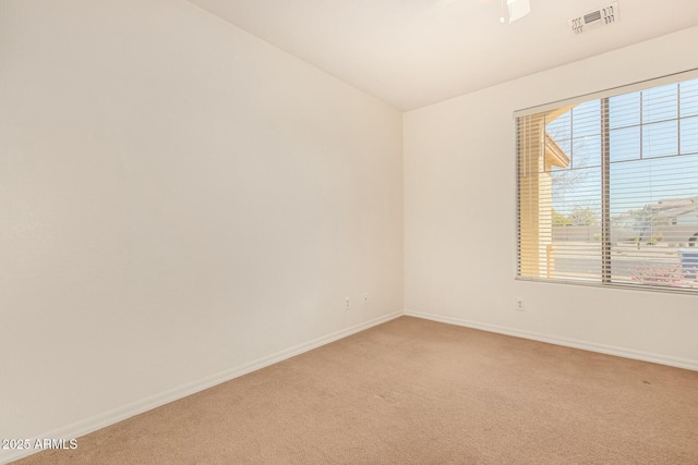 carpeted spare room with vaulted ceiling