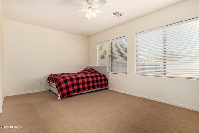 bedroom with ceiling fan and carpet floors