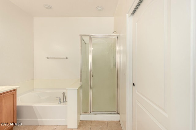 bathroom featuring vanity, independent shower and bath, and tile patterned flooring