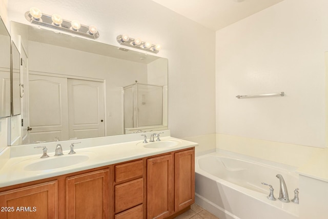 bathroom with vanity, tile patterned floors, and plus walk in shower