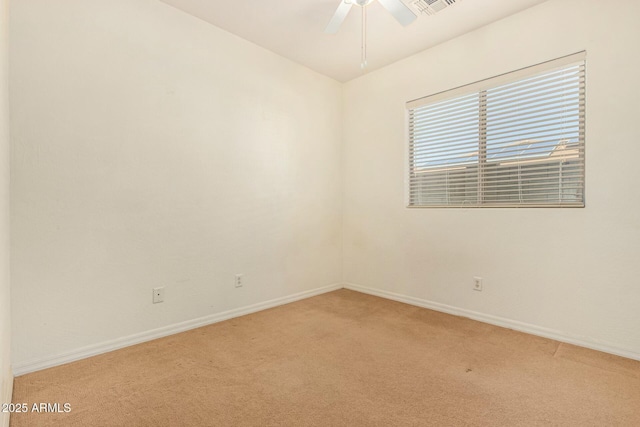 carpeted spare room with ceiling fan