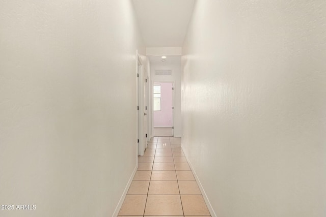 hallway with light tile patterned floors