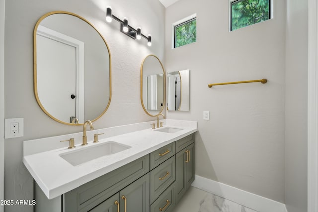 full bathroom featuring double vanity, marble look tile flooring, and baseboards