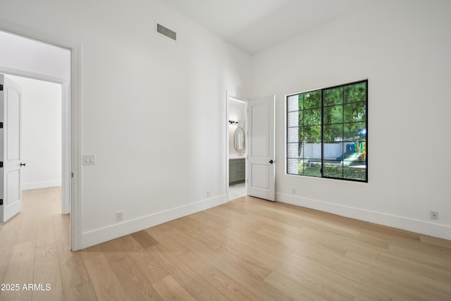 unfurnished room featuring light wood-type flooring and baseboards