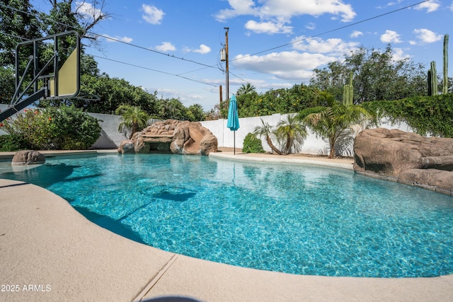 view of swimming pool with fence
