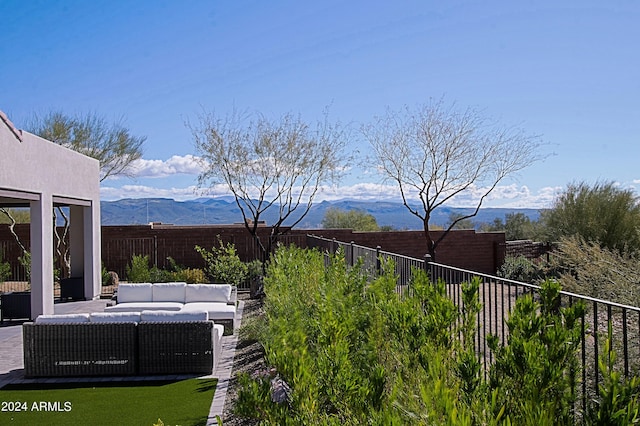 view of yard featuring an outdoor hangout area, a mountain view, and a patio area