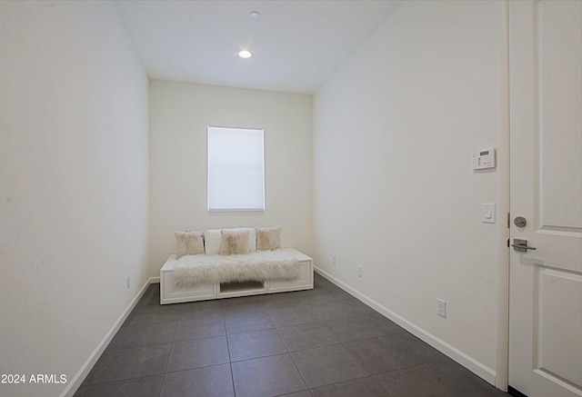 unfurnished bedroom with dark tile floors