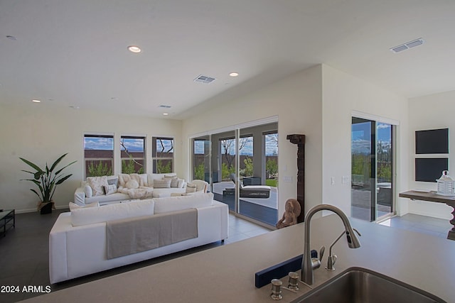 tiled living room featuring sink