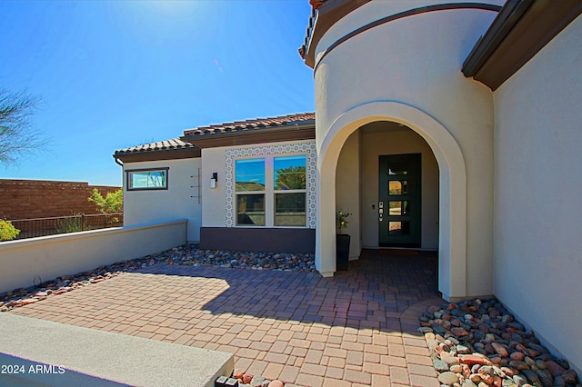 entrance to property with a patio