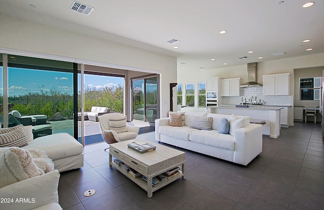 living room featuring dark tile flooring