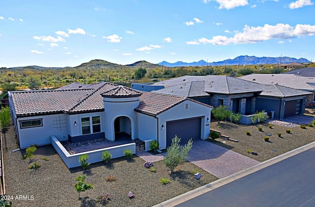 view of front of house featuring a mountain view and a garage