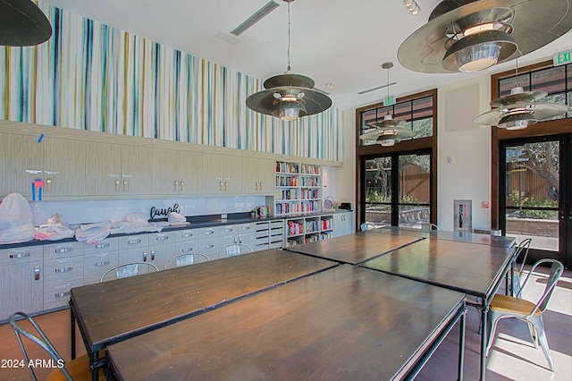 kitchen featuring decorative light fixtures, backsplash, ceiling fan, light brown cabinetry, and french doors