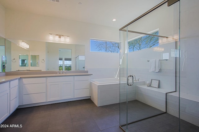 bathroom with shower with separate bathtub, tile floors, and oversized vanity