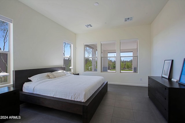 bedroom with dark tile floors