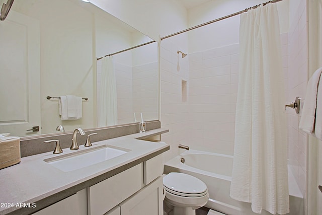 full bathroom featuring shower / bathtub combination with curtain, toilet, and vanity