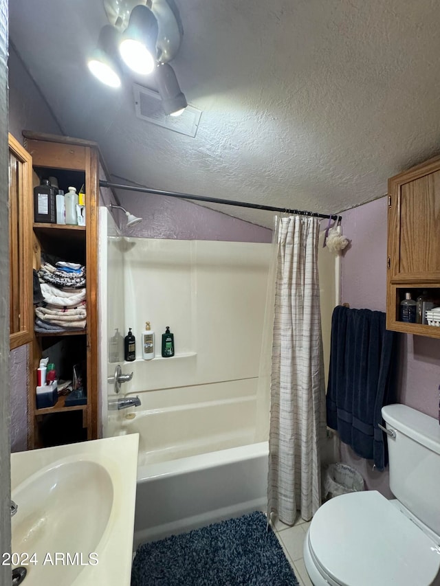 full bathroom featuring toilet, tile patterned floors, shower / bath combination with curtain, and a textured ceiling