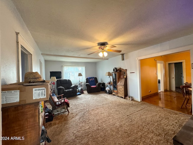 interior space featuring ceiling fan, a textured ceiling, and carpet flooring