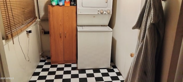 clothes washing area with laundry area, stacked washer and dryer, and tile patterned floors