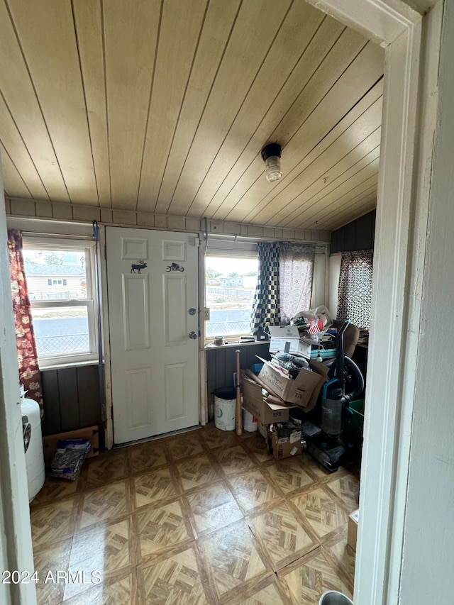 interior space with light parquet floors, wooden ceiling, and a healthy amount of sunlight