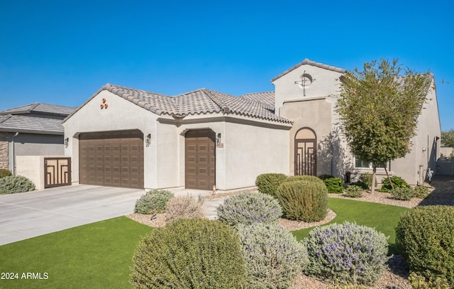 mediterranean / spanish home featuring a garage