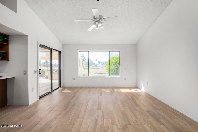 unfurnished room featuring ceiling fan, a textured ceiling, and light wood-type flooring