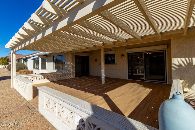 view of patio featuring a pergola and a deck