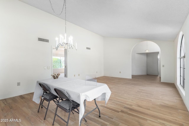 dining room featuring a notable chandelier and light wood-type flooring