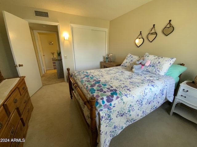 bedroom with light carpet and a closet